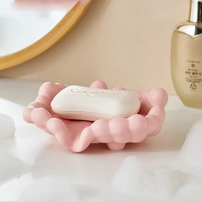 A ceramic soap dish with a whimsical cloud design, perfect for elevating your bathroom decor.