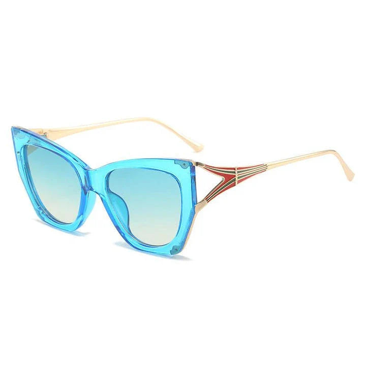 Refined cat eye sunglasses with blue gradient lenses and sleek metal frames, offering timeless British style and UV400 protection.