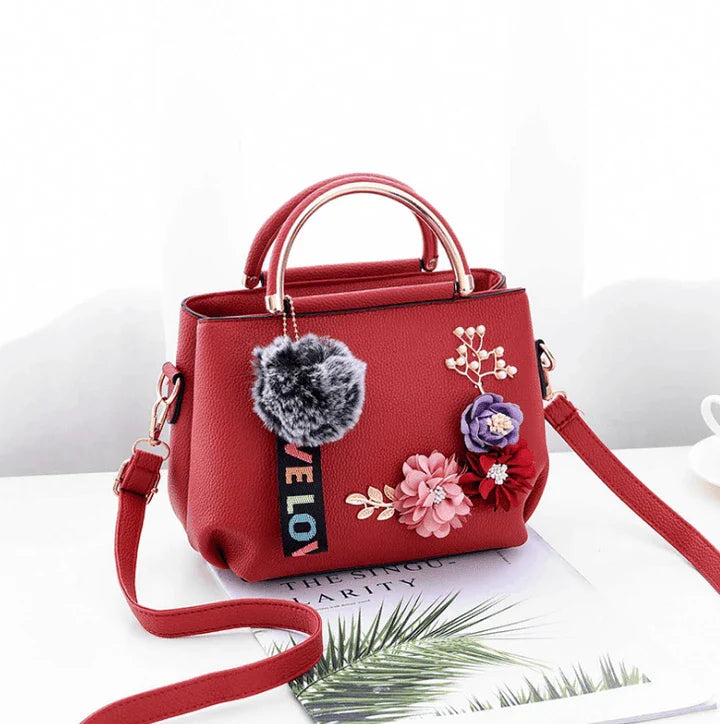 Elegant leather tote bag with delicate flower embellishments, perfect for modern British fashion