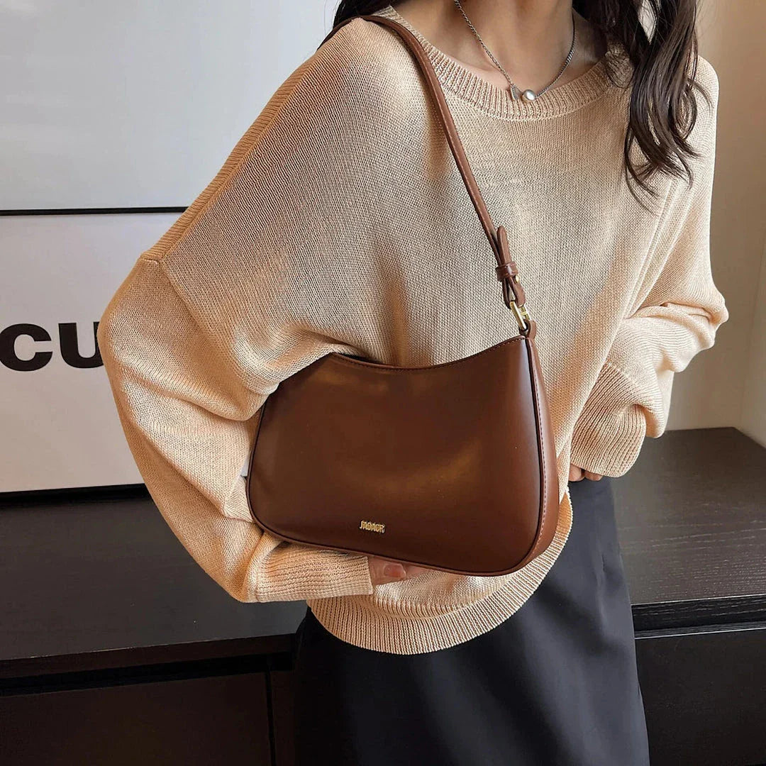 Luxury red leather crossbody bag with sleek design and elegant details