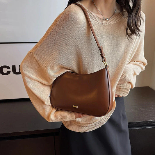 Luxury red leather crossbody bag with sleek design and elegant details