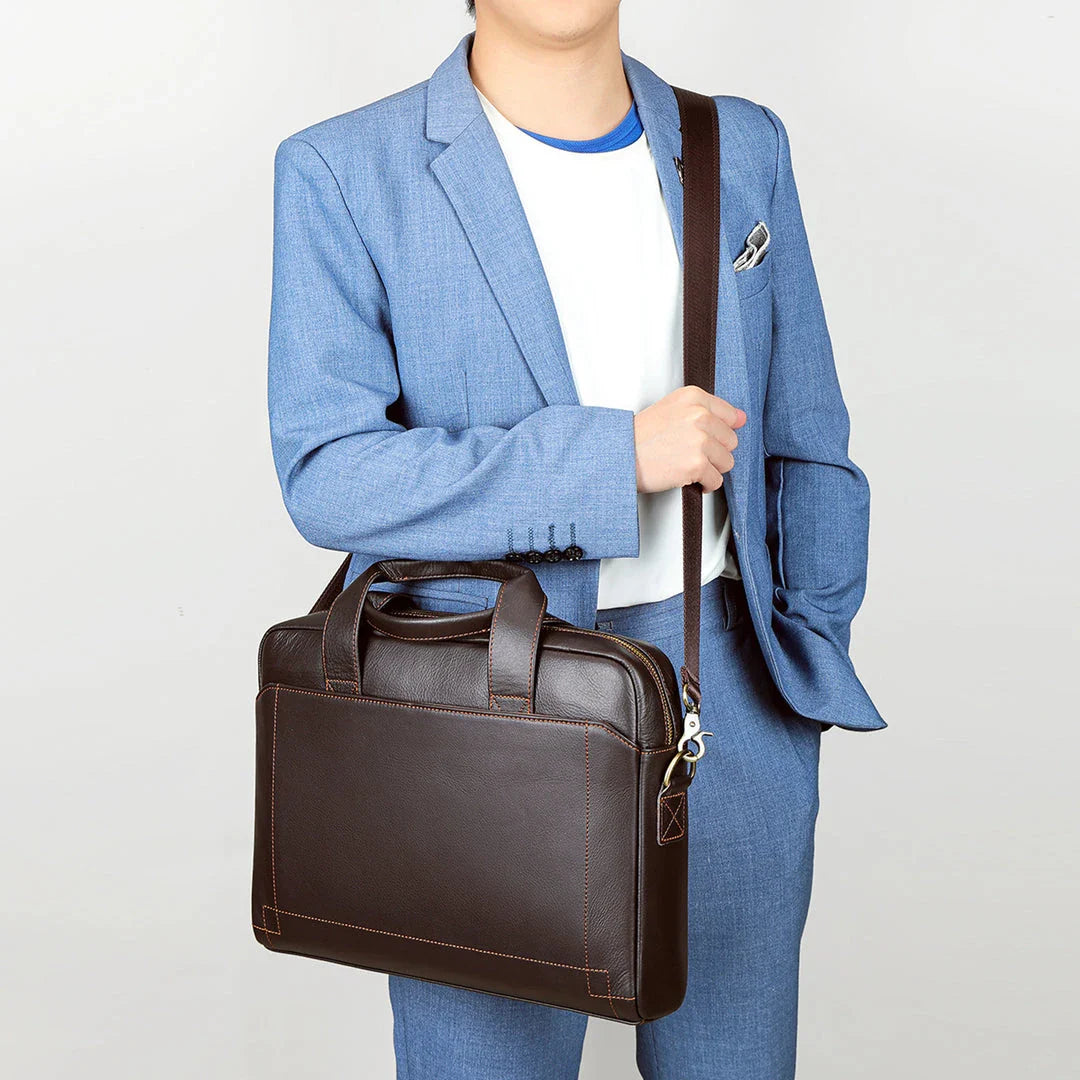 Men's genuine leather briefcase in dark coffee colour, featuring a spacious interior and adjustable shoulder strap for versatile carrying