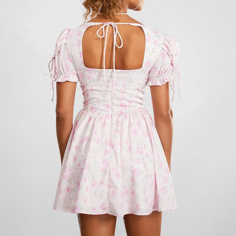 Floral mini dress with puff sleeves, featuring a V-neck, backless design, and A-line silhouette in a vibrant floral print