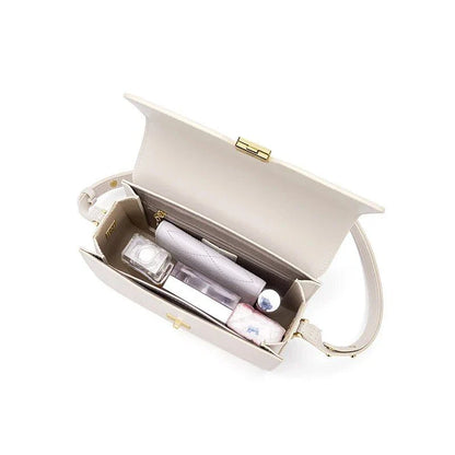 Stylish British-inspired leather shoulder and crossbody bag in black, tan, and navy colours