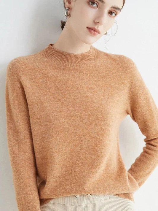 A woman wearing a luxurious Merino wool mock-neck jumper in a stylish autumnal outfit