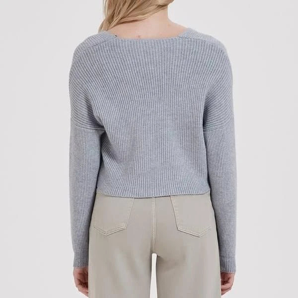 A cosy, brown V-neck knitted jumper with a relaxed, comfortable fit and a touch of vintage-inspired style.