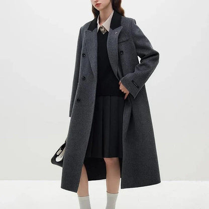 A sophisticated and stylish dark grey woollen coat for women, designed with a timeless double-breasted closure and notched collar.