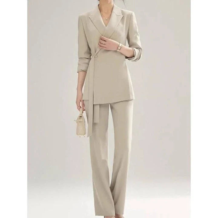 A two-piece vintage-inspired office suit with a long-sleeve blazer and high-waisted trousers, designed for the modern professional woman.