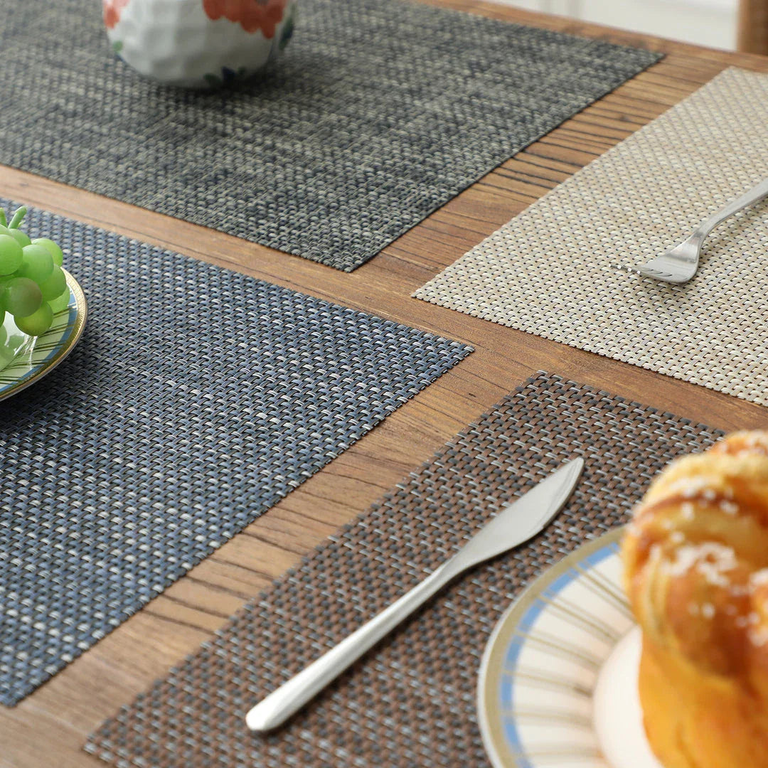 Stylish and durable waterproof placemats in black, protecting a dining table from spills and stains
