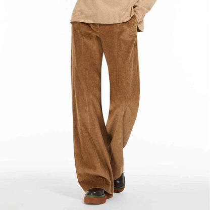 A pair of high-waist, wide-leg corduroy trousers in a classic red colour, designed for the modern British woman's wardrobe.