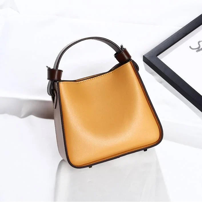 A stylish microfibre leather tote bag with a chic bucket shape and ruched detailing, perfect for the modern British woman.