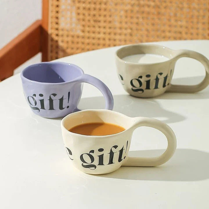 Handcrafted creative alphabet ceramic mug in beige, purple, and khaki colours for hot drinks like coffee and tea