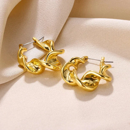 A pair of gold-toned stainless steel hoop earrings, showcasing a classic and sophisticated design