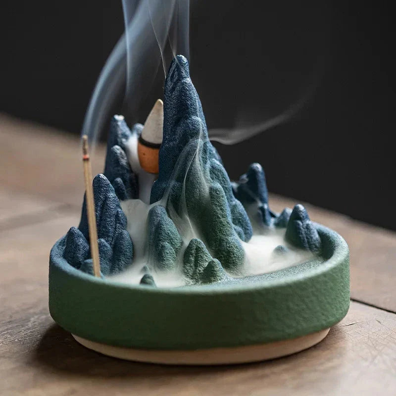 Elegant ceramic incense burner with a tranquil mountain and river design, creating a serene visual display