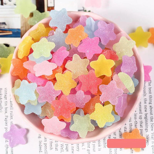 Heart and star-shaped nail charms with candy-inspired designs for creating unique and eye-catching nail art