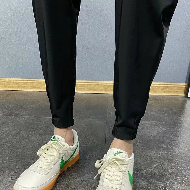 Premium slim-fit drawstring joggers in black and grey, featuring a tailored silhouette and adjustable waistband for a polished, comfortable look.