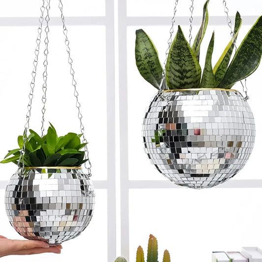 A sparkling silver disco ball hanging planter with reflective glass mirrors, adding a modern and stylish touch to any indoor or outdoor space.