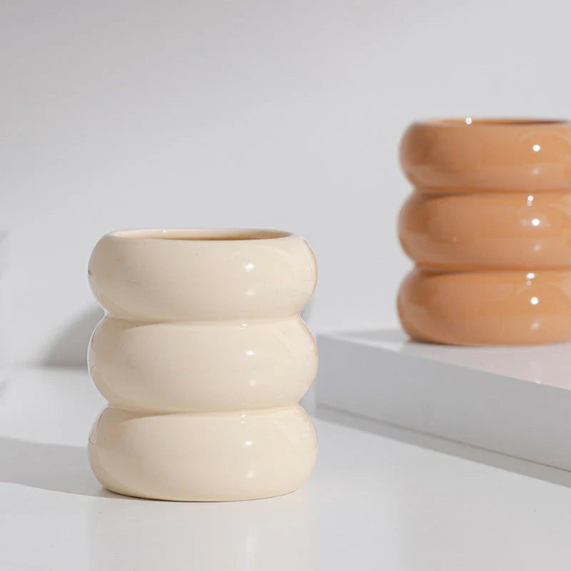 A white ceramic candlestick holder with a minimalist Nordic design, perfect for creating a cosy and sophisticated ambience in any room.