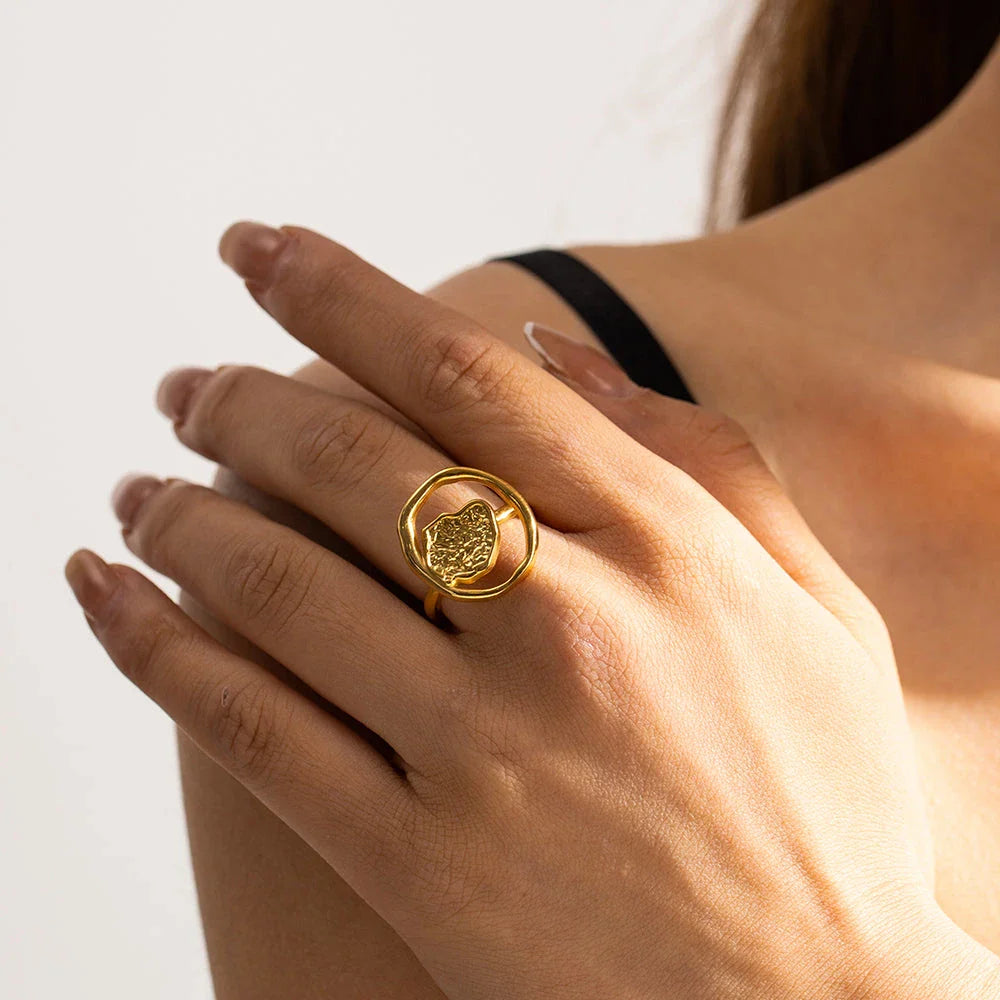 Elegant 18K gold-plated stainless steel ring with intricate hollow-carved design and vintage-inspired charm