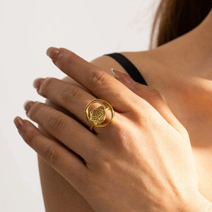 Elegant 18K gold-plated stainless steel ring with intricate hollow-carved design and vintage-inspired charm