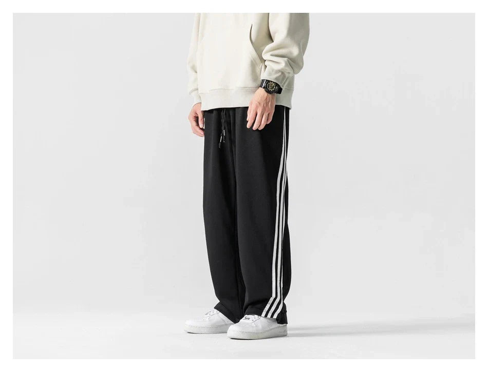 Stylish striped sports trousers in a relaxed, mid-waist design for versatile leisure and athletic wear