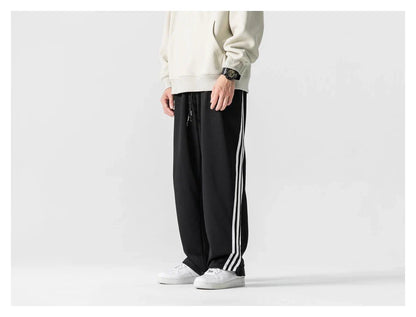 Stylish striped sports trousers in a relaxed, mid-waist design for versatile leisure and athletic wear