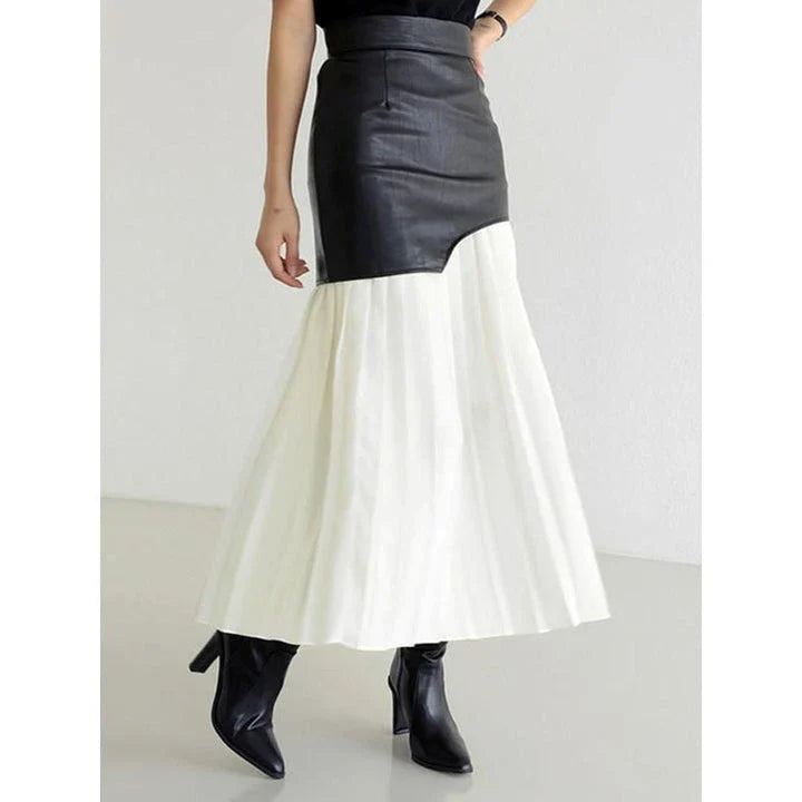 A stylish long pleated skirt featuring a sophisticated leather patchwork design and a flattering A-line silhouette