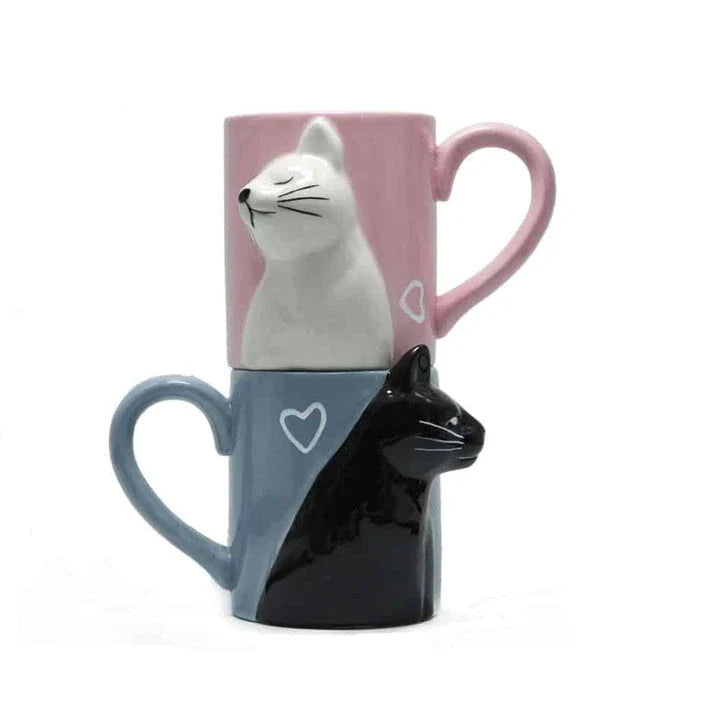 A pair of ceramic mugs featuring a charming design of two kissing cats, perfect for couples and cat lovers