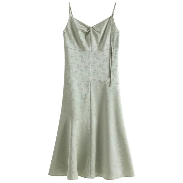Elegant mint green midi dress with spaghetti straps, featuring a flattering slim fit and beautiful embroidery detailing