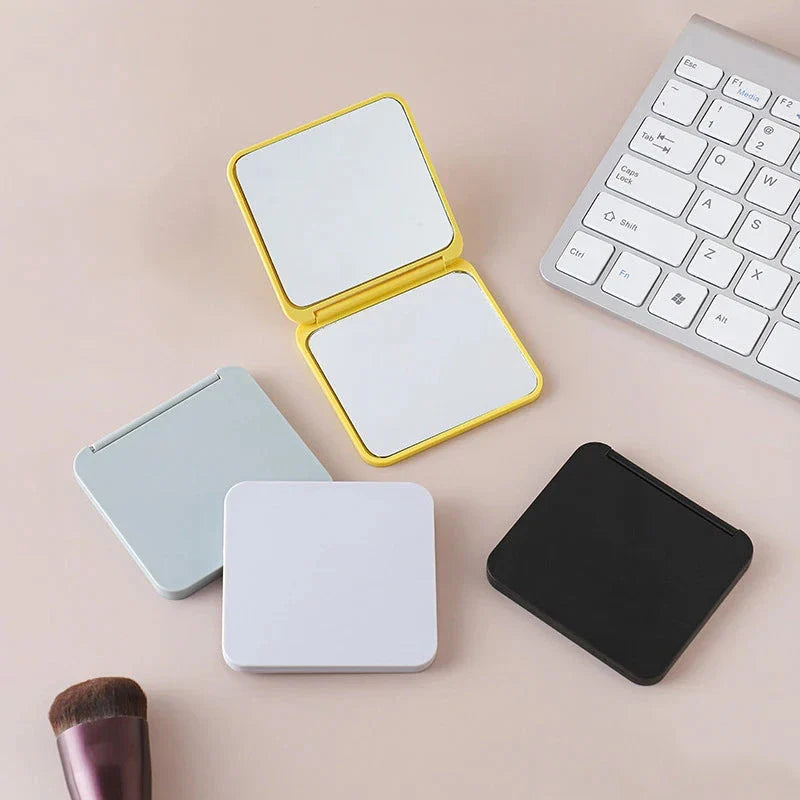 Compact double-sided makeup mirror in multiple vibrant colours, featuring a foldable design for easy portability