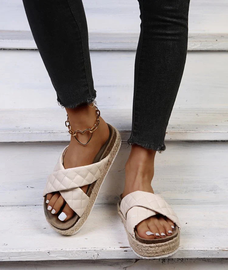 Elegant cross-toe platform sandals and slippers in a neutral creamy white hue, showcasing a contemporary and refined design for the discerning woman