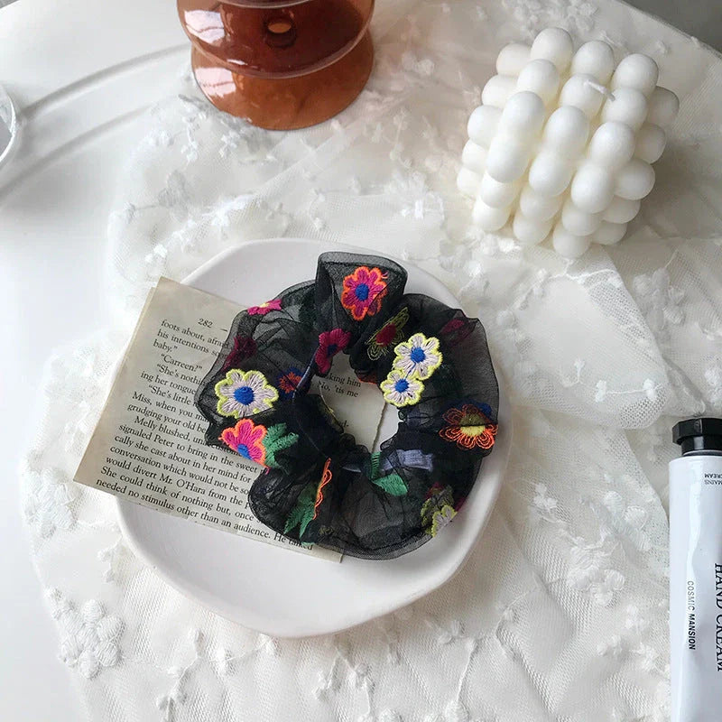 Handmade floral elastic hair bands with soft chiffon fabric and vibrant embroidered daisy patterns, perfect for enhancing everyday style in the UK.