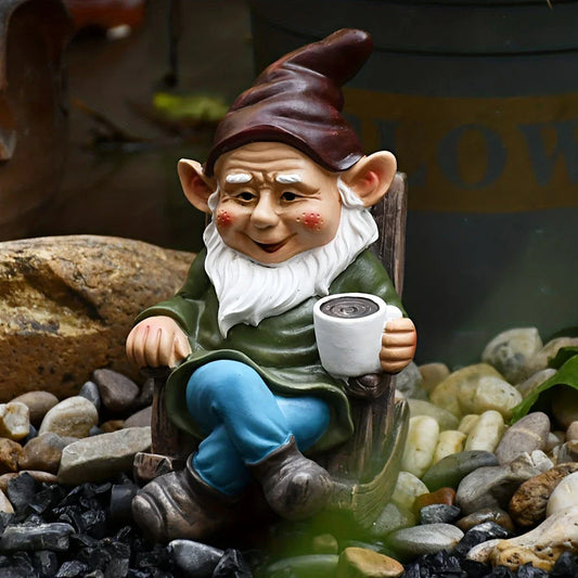 A charming garden gnome ornament made of durable resin, sitting in a rocking chair and sipping tea, adding whimsical personality to an outdoor space