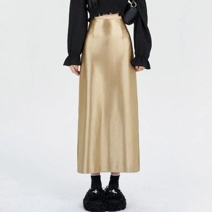 Luxurious silver satin maxi skirt with high-waist design and chic back split for elegant and versatile style.