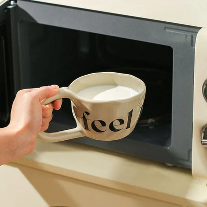 Handcrafted creative alphabet ceramic mug in beige, purple, and khaki colours for hot drinks like coffee and tea