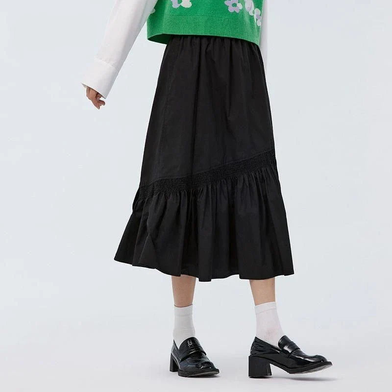 Elegant mid-length black skirt with an A-line silhouette, natural waistline, and unique irregular hemline, perfect for the modern British woman's wardrobe