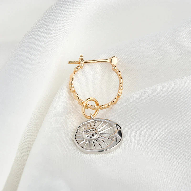 Elegant sterling silver sun and moon earrings with a refined geometric design