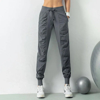 Premium women's sports trousers with drawstring waist and pockets, made of high-quality nylon fabric for comfort and versatility.