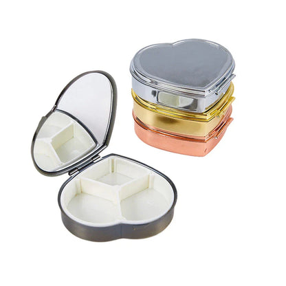 Elegant heart-shaped metal pill box with mirror for organized storage and convenient touch-ups