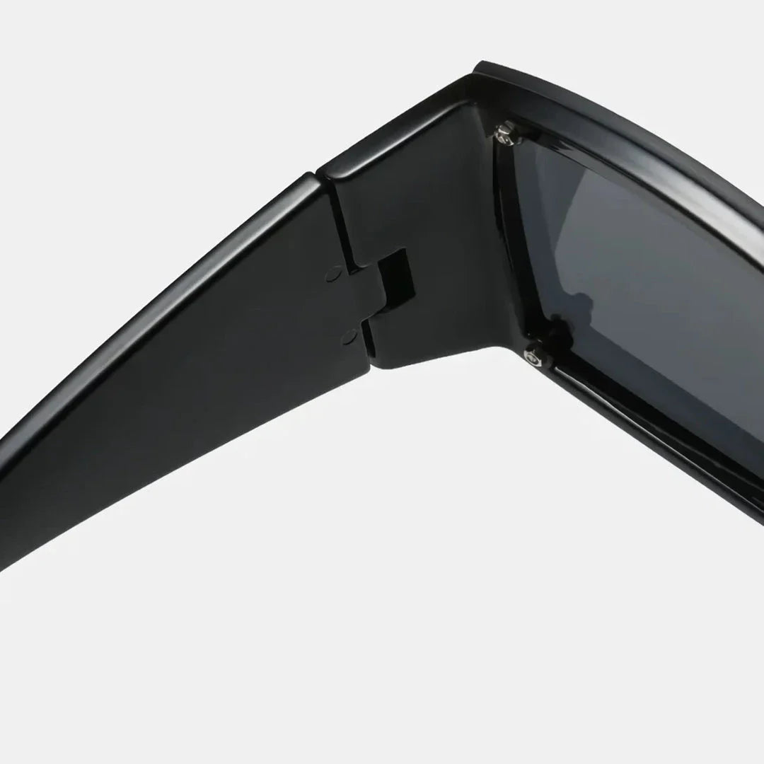 Oversized square sunglasses with black lenses and a durable plastic frame, offering UV400 protection and adaptive photochromic technology.