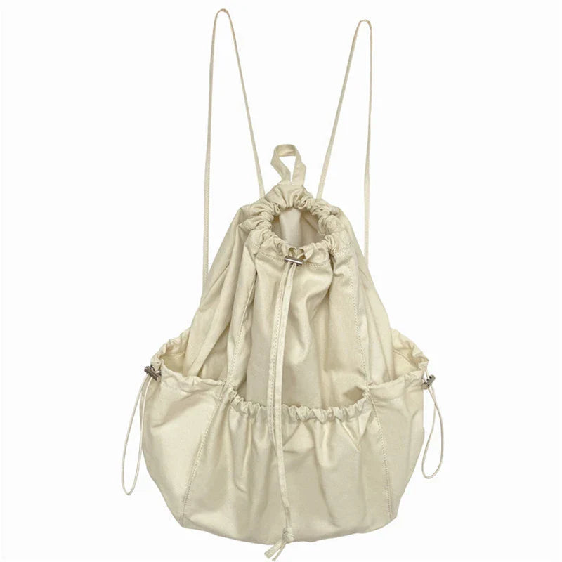 A stylish drawstring bucket bag in white, black, or brown colour options, featuring a spacious interior and adjustable closure for modern British women.