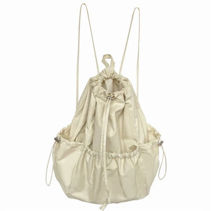 A stylish drawstring bucket bag in white, black, or brown colour options, featuring a spacious interior and adjustable closure for modern British women.