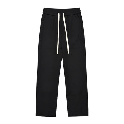 Sophisticated retro-style casual suit trousers in black and apricot colours, featuring a sleek straight-leg silhouette and distinctive back slit