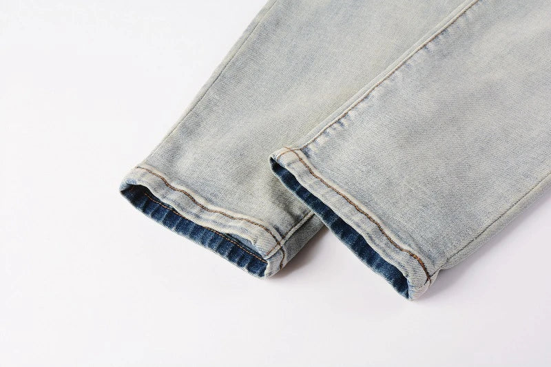 Stylish distressed denim jeans with a skinny, knee-exposed silhouette for a contemporary, high-street fashion look