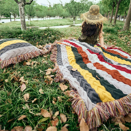 Elegant wool blanket with stylish plaid pattern and fringed tassels, perfect for cosy home decor and outdoor adventures.