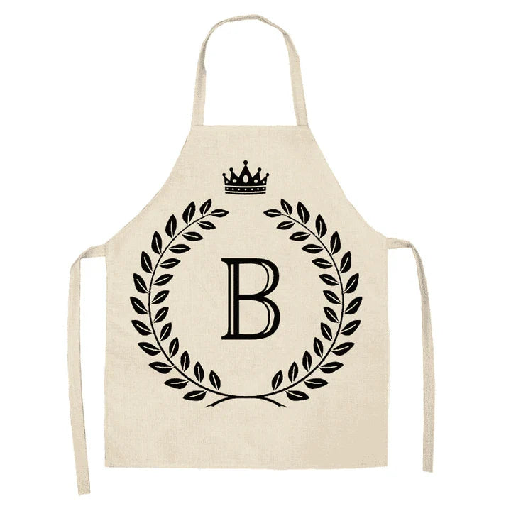 A high-quality kitchen apron featuring a charming crown and letter print design in a premium cotton and linen blend fabric.