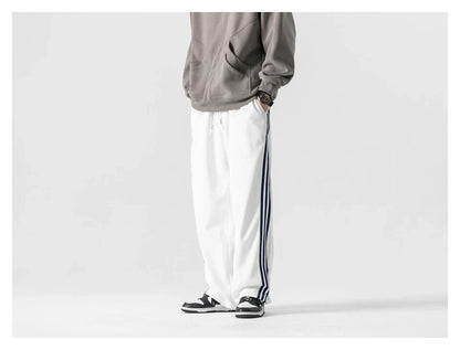 Stylish striped sports trousers in a relaxed, mid-waist design for versatile leisure and athletic wear