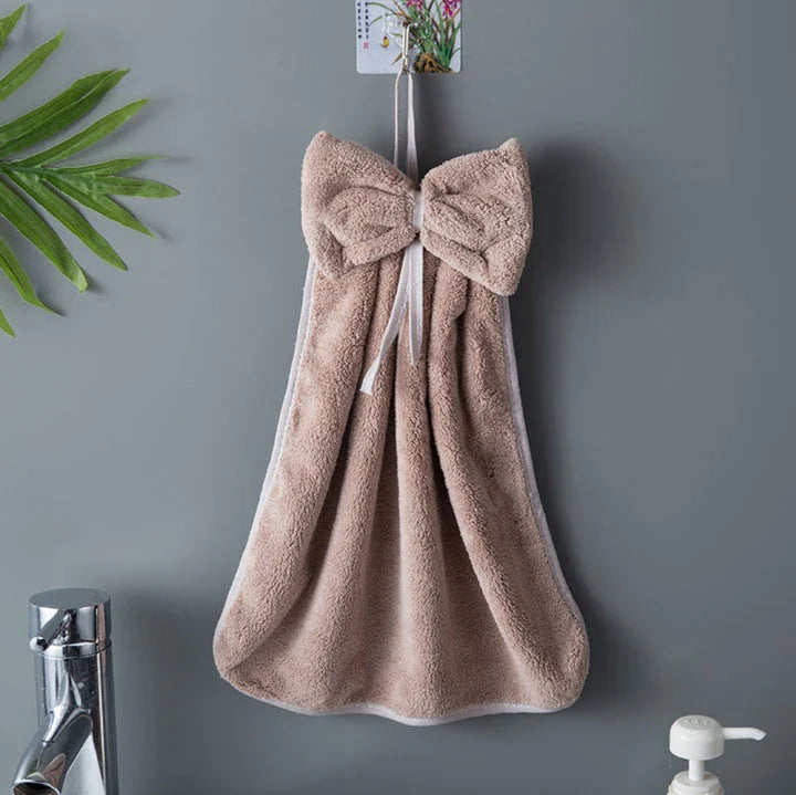 Elegant coral fleece hand towels with a unique bow design, perfect for kitchen and bathroom use