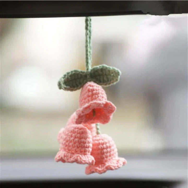 Charming knitted car plant decor with hanging white rope and green and white colour scheme