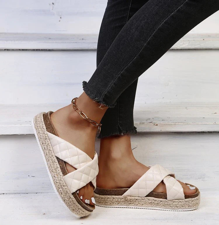 Elegant cross-toe platform sandals and slippers in a neutral creamy white hue, showcasing a contemporary and refined design for the discerning woman